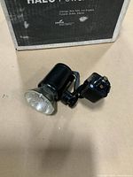 Track light head front view with lens and adapter