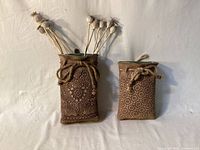 Both ceramic wall vases upright displaying size difference and pattern