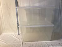 Both clear totes stacked, ruler showing height