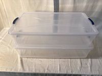 two nested clear plastic totes with lids