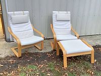 Two IKEA Poäng chairs and ottoman outdoors showing frames and cushions