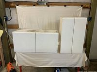 Front view of both white metal cabinets closed