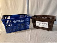 Blue and brown plastic shopping baskets side by side