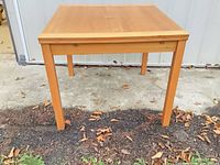 Full view of square wooden dining table closed