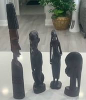 Group view of the four Makonde ebony sculptures