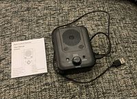 Front view of ultrasonic anti-bark device with user manual and USB cable