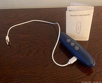 Repeller with cable and manual displayed on table