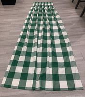 Full view of one drapery panel laid flat showing pattern and gathered top