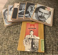 DVD cases fanned out with booklet in foreground