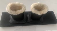 Top view of two faux leather glasses holders on base