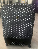 Front view of Heys black and white polka-dot suitcase