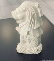 Left side view of white Merlion figurine
