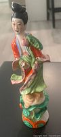 Full view of porcelain Guanyin figurine on lotus base
