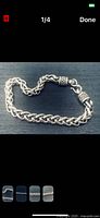 Sterling silver braided bracelet coiled to show weave and clasp detail