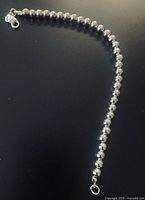 Full view of sterling silver beaded bracelet laid out straight showing lobster clasp and SS925 tag