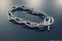 Bracelet close-up showing interlocking links and toggle clasp