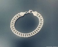 Full view of bracelet closed, showing curb links and clasp