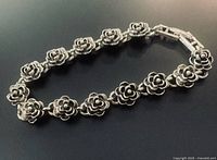 Close-up of sterling silver rose link bracelet clasped