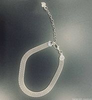 Full view of sterling silver braided bracelet laid flat