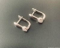 Pair of sterling silver earrings showing lever-back design and zirconia fronts
