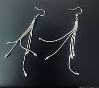 Both earrings laid flat to show overall design and condition