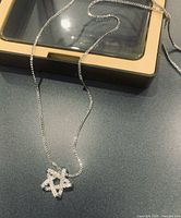 Close view of sterling silver star pendant with chain