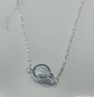 Close-up of sterling silver double halo cubic zirconia pendant on chain