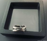 Ring in display box, showing double-layer wave design