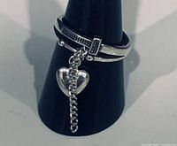 Front view of sterling silver ring showing chain tassel and heart charm