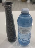 Vase beside water bottle showing scale
