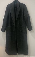 Full front view of the long grey/black check Zara coat hanging
