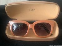 Sunglasses in open Zara case, front view