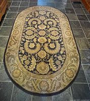 Full view of oval floral rug on floor