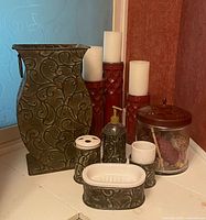 Group view of all items including vase, candle holders with candles, bathroom counter set, and glass jar
