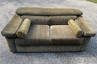 Front view of modern loveseat with bolsters
