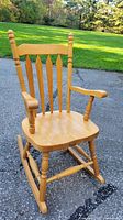 Full view of oak rocking chair showing design and finish
