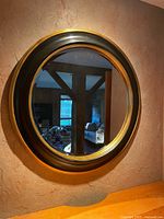 Full view of round mirror on wall