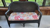 full view of black wicker loveseat