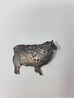 front view of textured sterling silver sheep brooch