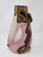 Front view of pink satin glass vase with bronze floral applique