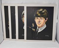 Front view showing all four Beatles prints fanned