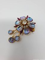 Front view of Jewel Crest floral brooch with dangling drops