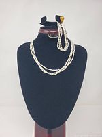 Necklace and bracelet displayed on bust