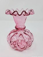 Front view showing bulbous lattice body and ruffled rim