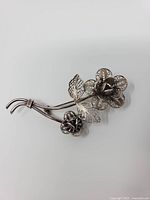 Front view of sterling silver filigree floral brooch
