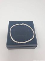 Bracelet laid flat on black box lid