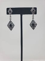 Front view of both earrings showing design and stones