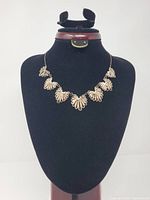 Full view of necklace on display bust showing seven filigree panels