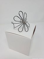 full view of sterling silver flower cuff bracelet on white box