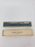 Pencil in open box showing branding on lid interior